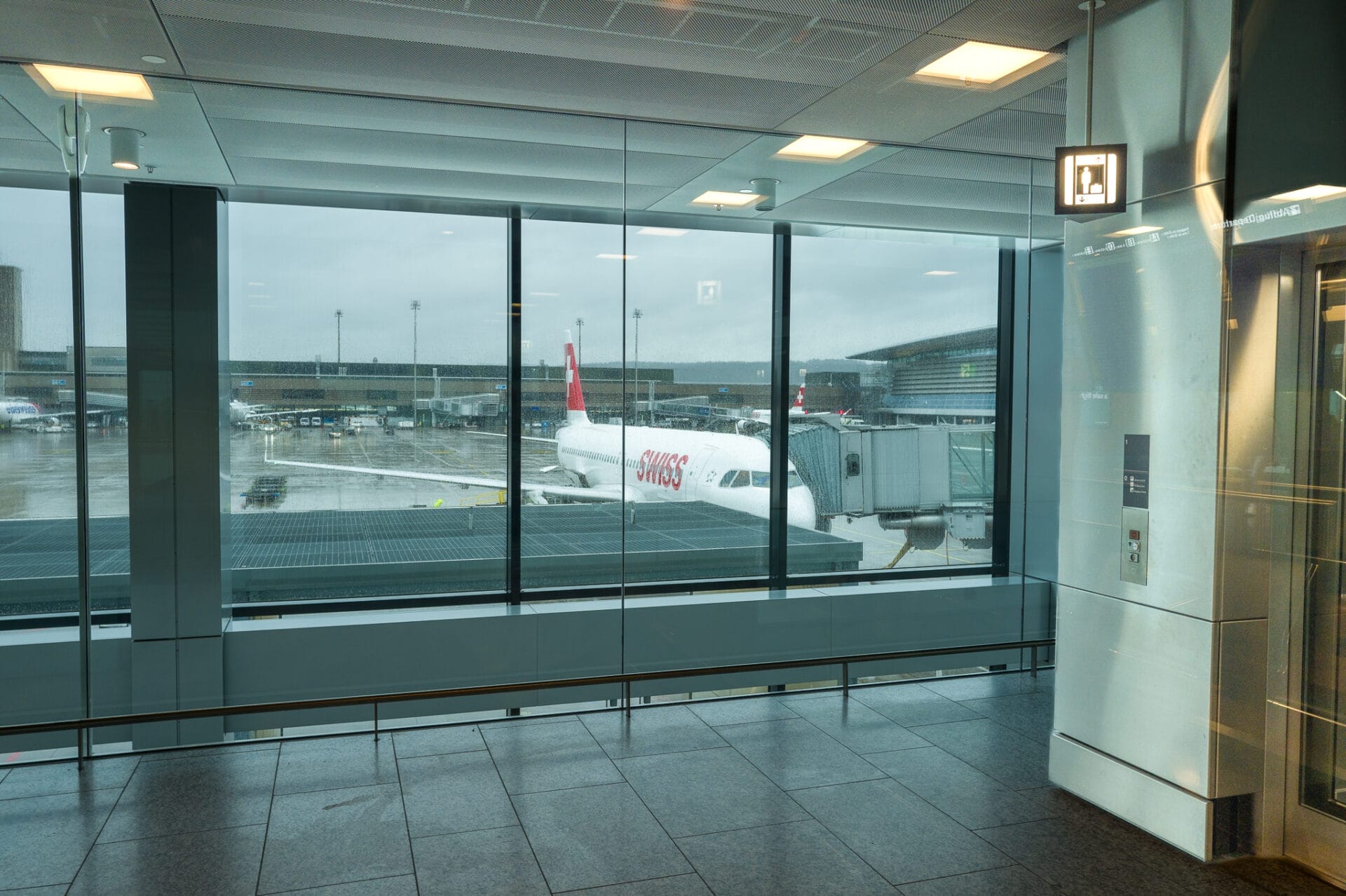 Airport terminal view with aircraft at gate.