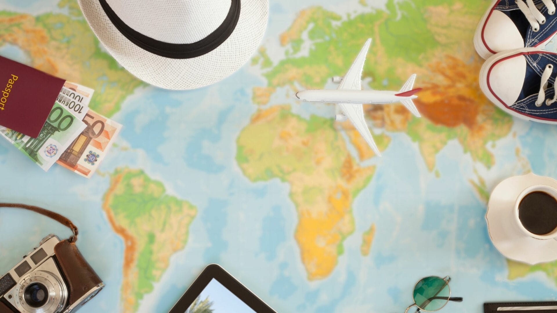 Person planning travel with map, phone, and passport.